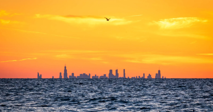 view-of-chicago-from-indiana-dunes Chicago skyline visible across Lake Michigan from a beach at Indiana Dunes National Park